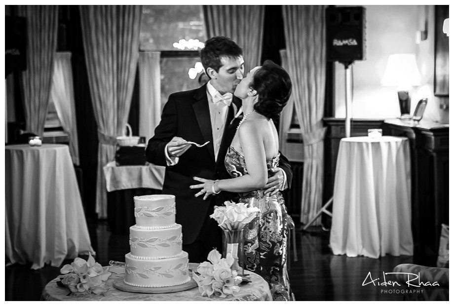 wedding reception cake cutting and kiss
