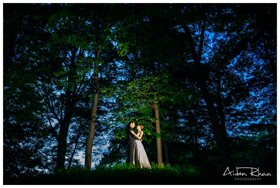 wide angle portrait of a couple on wedding day in the woods