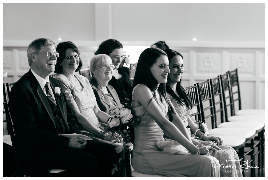 family watching bride and groom during ceremony